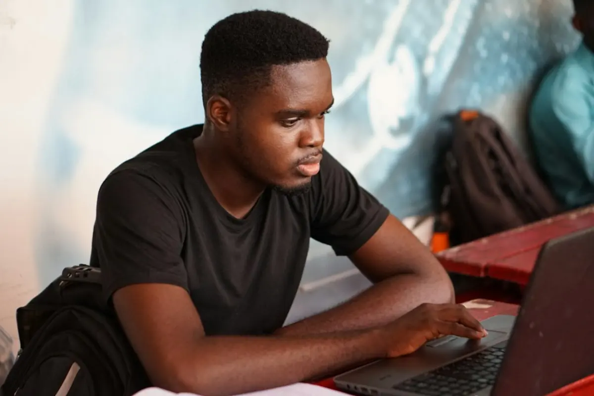 Student working on a laptop, study abroad planning